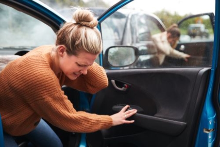 Girl holding her neck after a car wreck