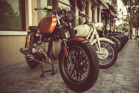 line of motorcycles on the sidewalk