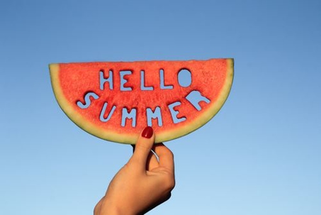 watermelon slice with the words hello summer carved out in it